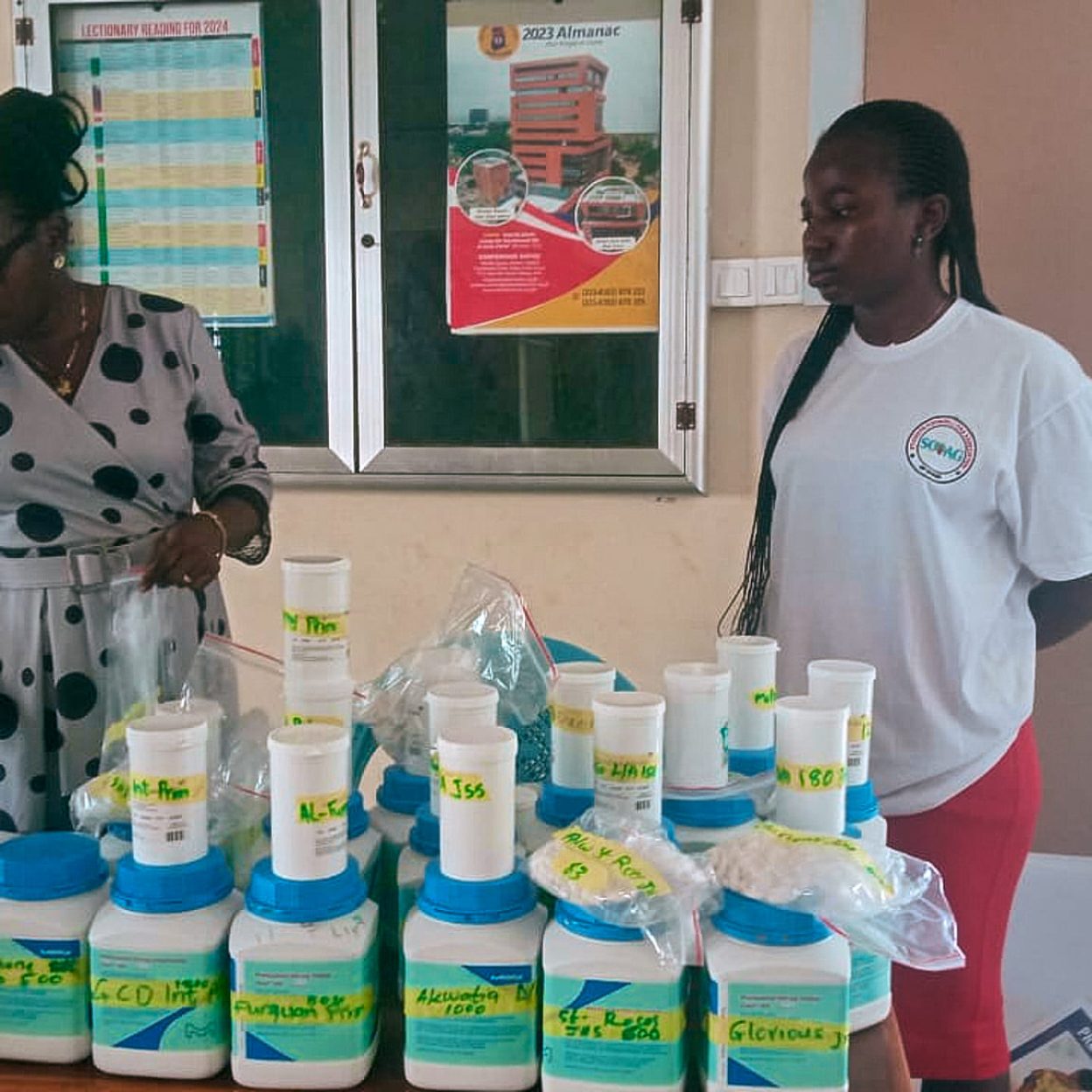 Display of educational materials used to NTDs and WASH awareness. Women presenting health and hygiene educational materials on a table.